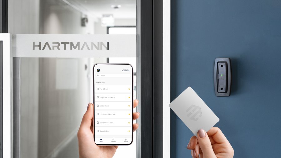Hand presenting a proximity fob to a Hartmann reader with access-granted indicator